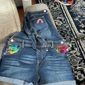 Jordache Denim overall shorts with sequin pockets.